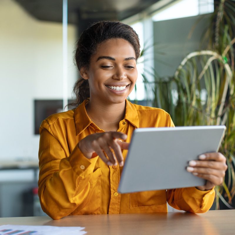 modern-technologies-in-business-happy-black-businesswoman-using-modern-digital-tablet-working.jpg