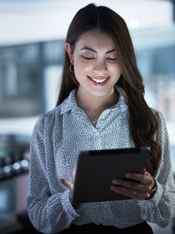 shot-of-a-young-businesswoman-using-a-digital-tablet-in-an-office-at-night.jpg